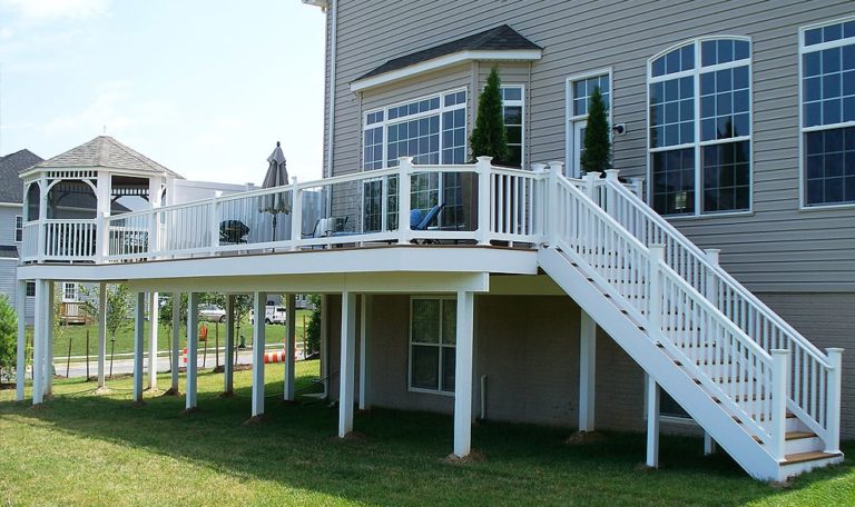 Composite Deck with white vinyl railing with glass pickets and vinyl gazebo white beam and support post wraps-min