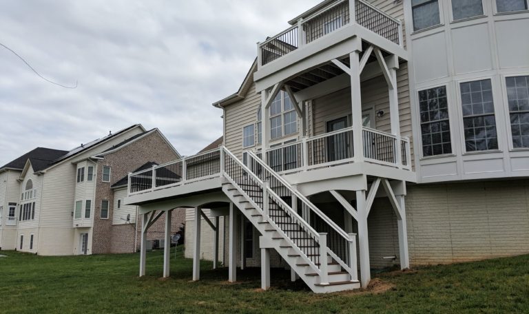 Trex Select Saddle Decking with White Washington Railing and Black Aluminum Balusters + Fascia and Support Posts and Beams are wrapped in White Vinyl in Bowie MD