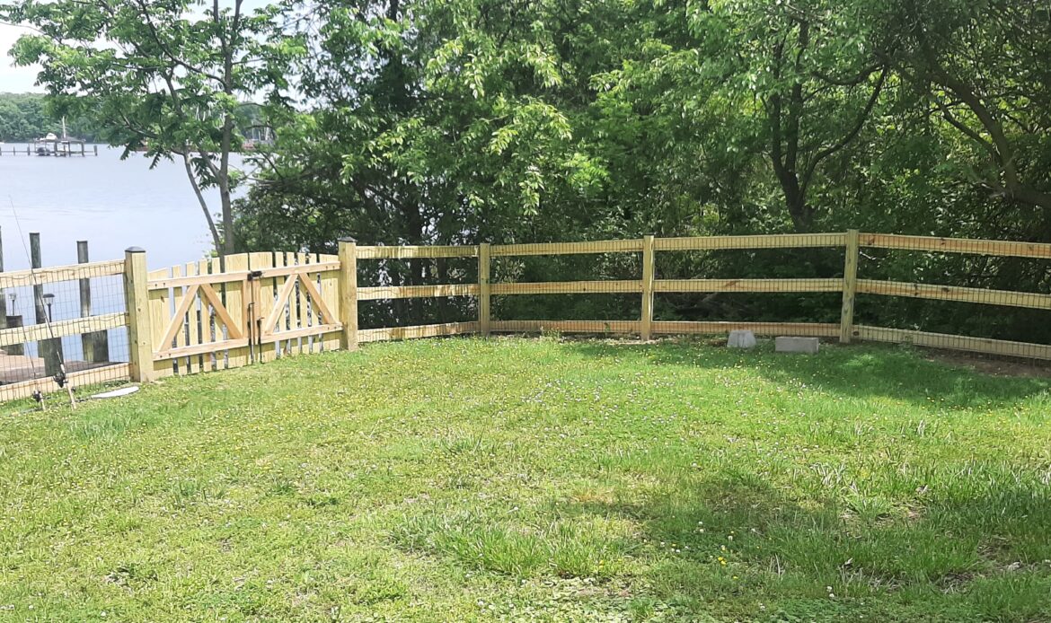 Pressure treated 3-rail ranch rail fence with black mesh and double arched gate