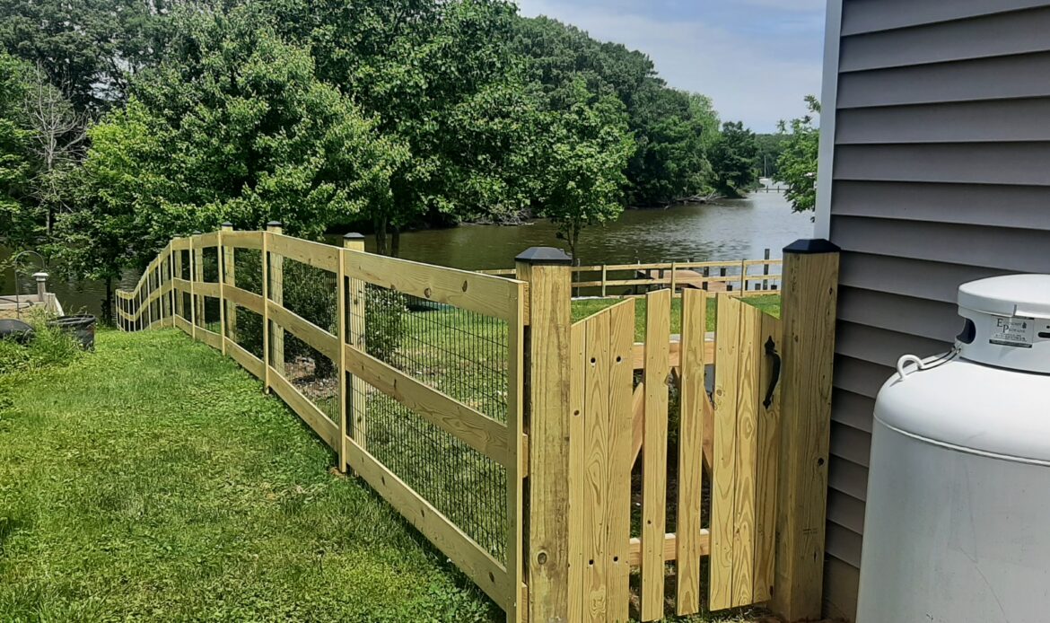 Pressure treated 3-rail ranch rail fence with black mesh and single arched gate (2)