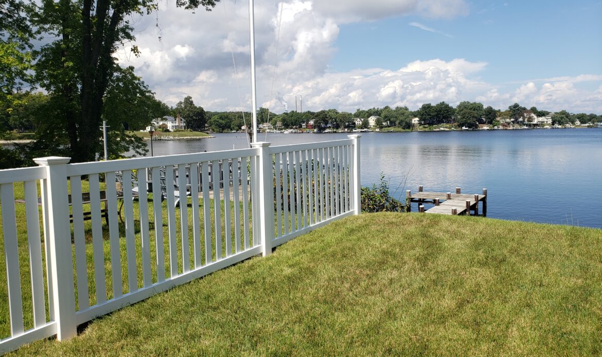 White vinyl pool code picket fence