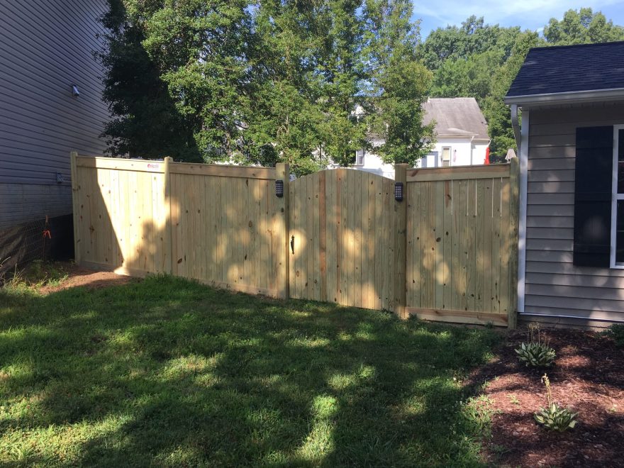 6 foot high Pressure Treated Vertical Board Fence with Facia Board on Top and Bottom and Dog Earred Posts + Arched Walk Gate