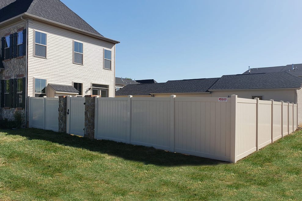 6 foot high tan vinyl privacy fence and walk gate