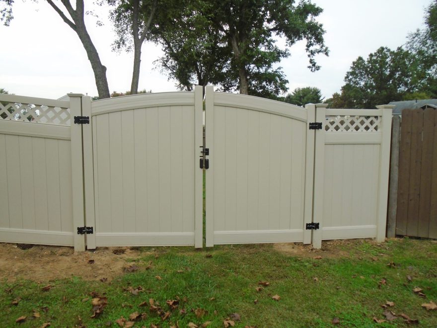 Tan Vinyl Privacy Fencing with Lattice top and double arched gate