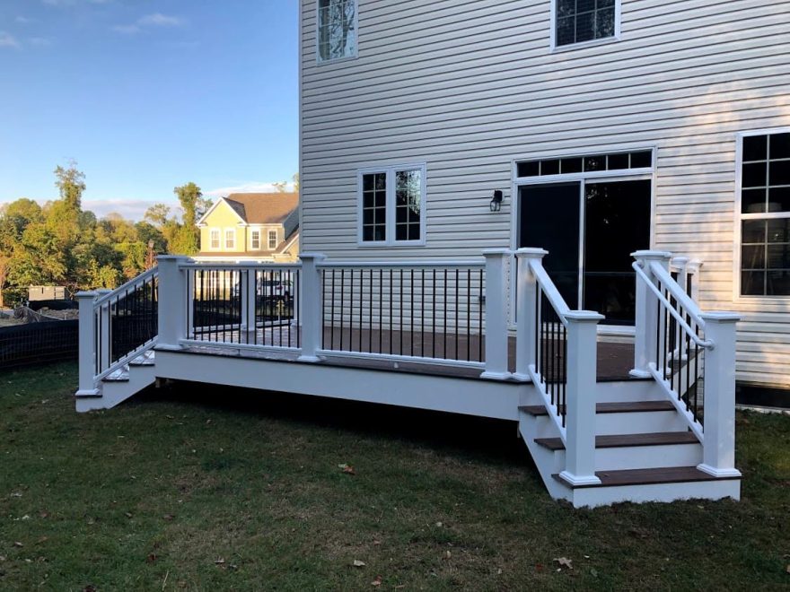 TimberTech Pro Legacy Collection Sapele Deck with White TimberTech Permier Handrail with Round Aluminum Hammered Bronze Balusters + Deck is wrapped in White Vinyl Fascia in Arnold MD