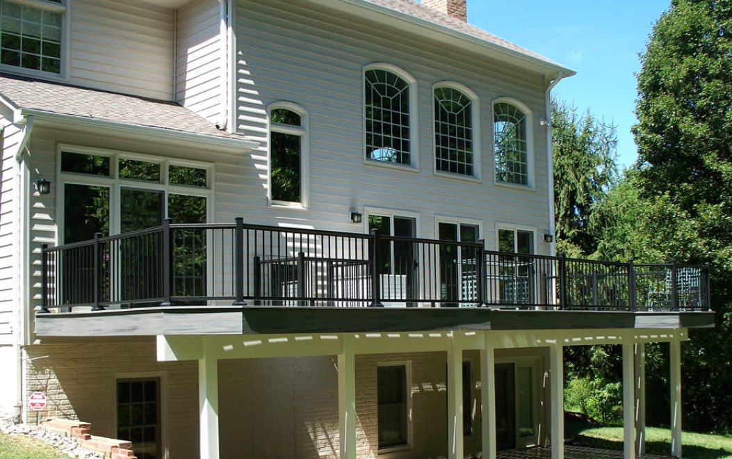 Trex Composite Deck with Black Aluminum railing and gray fascia wrap white post and beam wrap