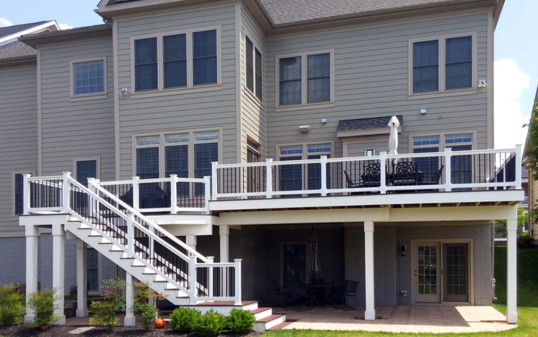 Trex Select Madeira Deck Boards with white Washington Railing with black aluminum balusters White Vinyl Wrap on support beams and posts and fas