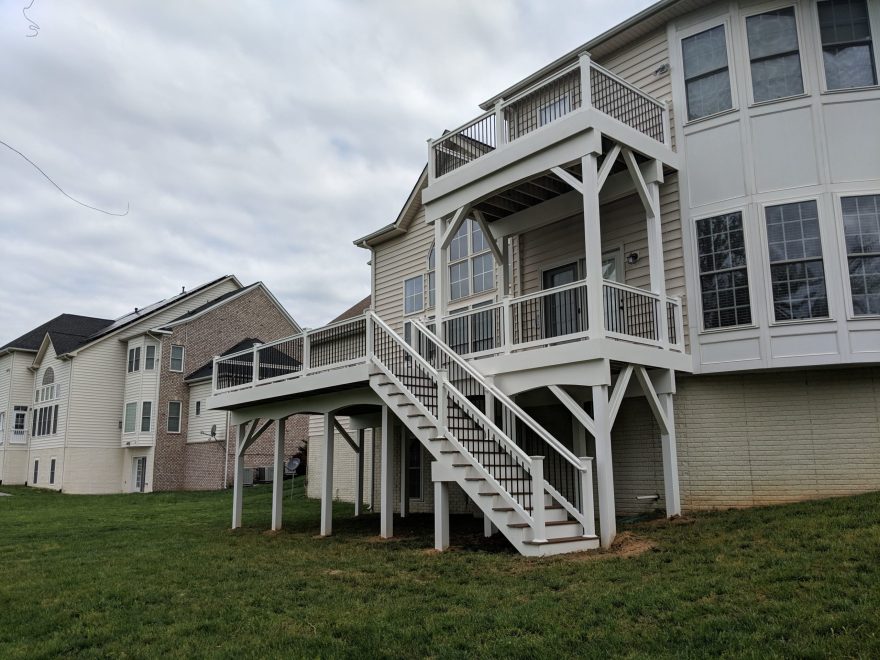 Trex Select Saddle Decking with White Washington Railing and Black Aluminum Balusters + Fascia and Support Posts and Beams are wrapped in White Vinyl in Bowie MD