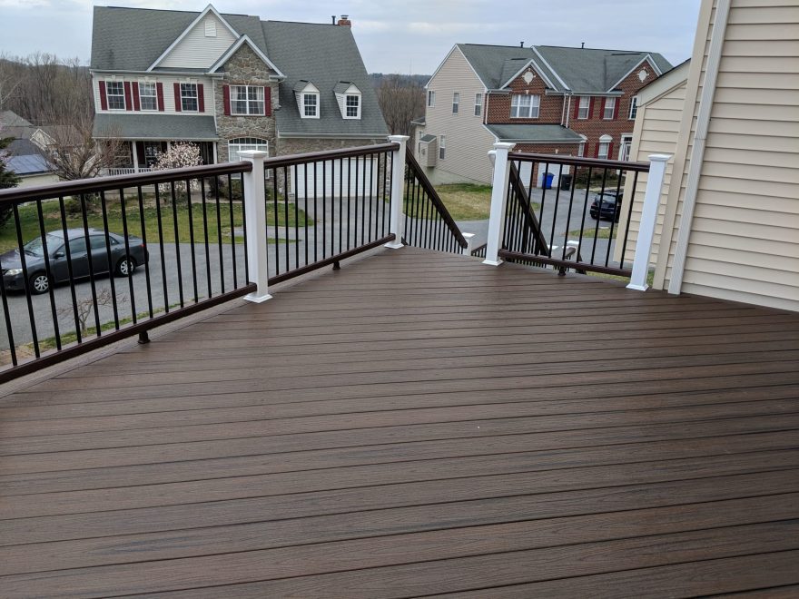 Trex Transcend Spiced Rum Deck Boards in a Diagonal Pattern with Trex composite railing in matching Spiced Rum with white composite posts and black aluminum baluster