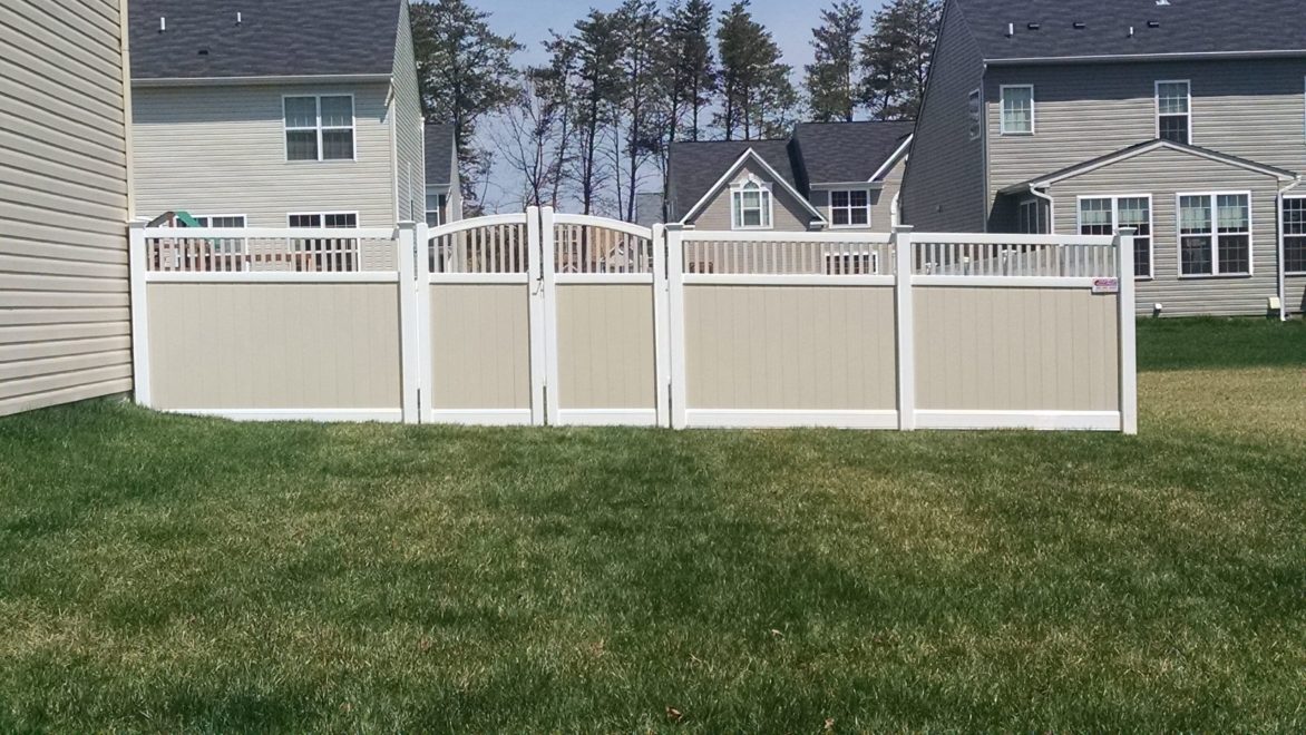 Two toned tan and white vinyl privacy fence with Closed Spindle Topper