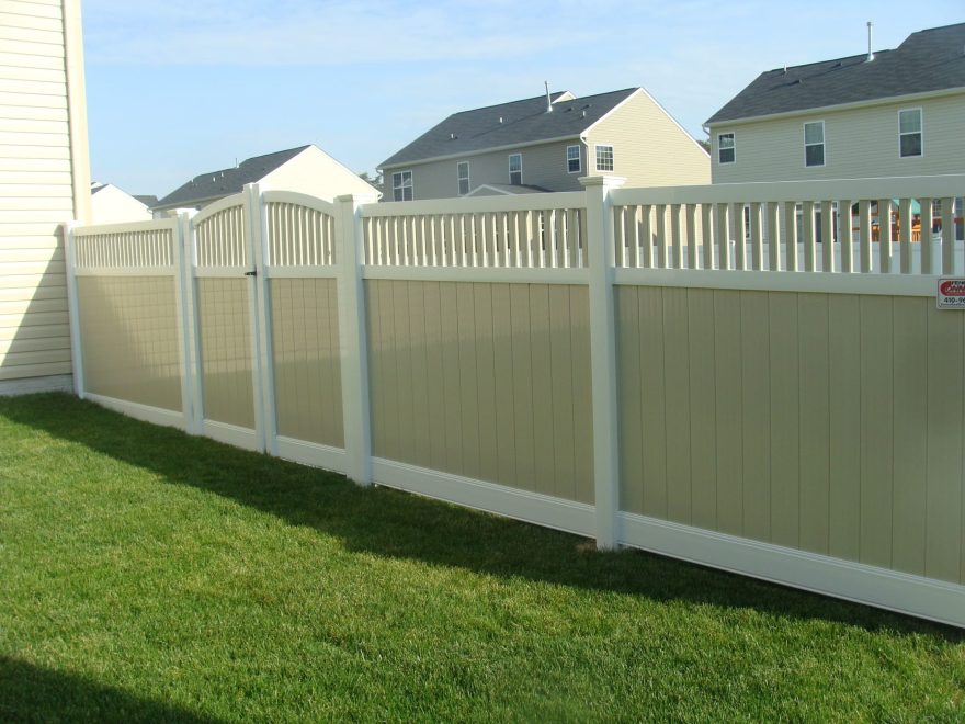 Two toned tan and white vinyl privacy fence with tan closed spindle infill top