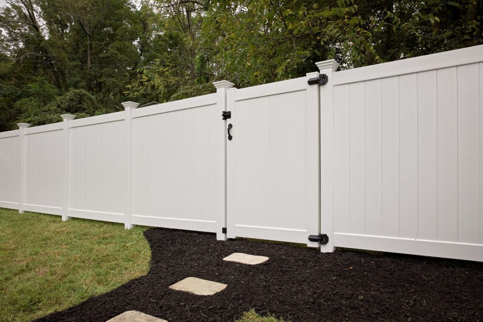 White vinyl privacy fence with single gate and Contemporary post caps